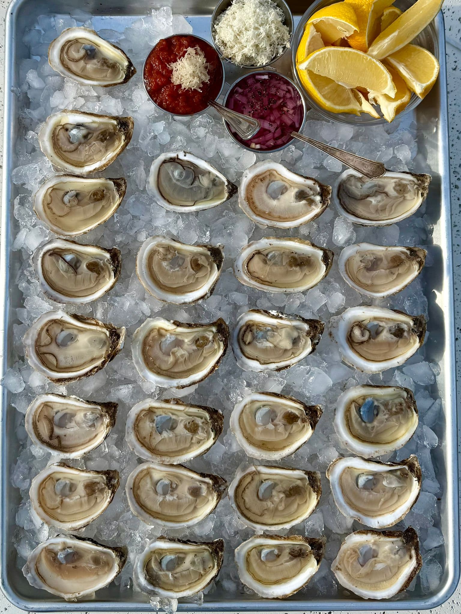 Fresh oysters on ice with classic accompaniments.