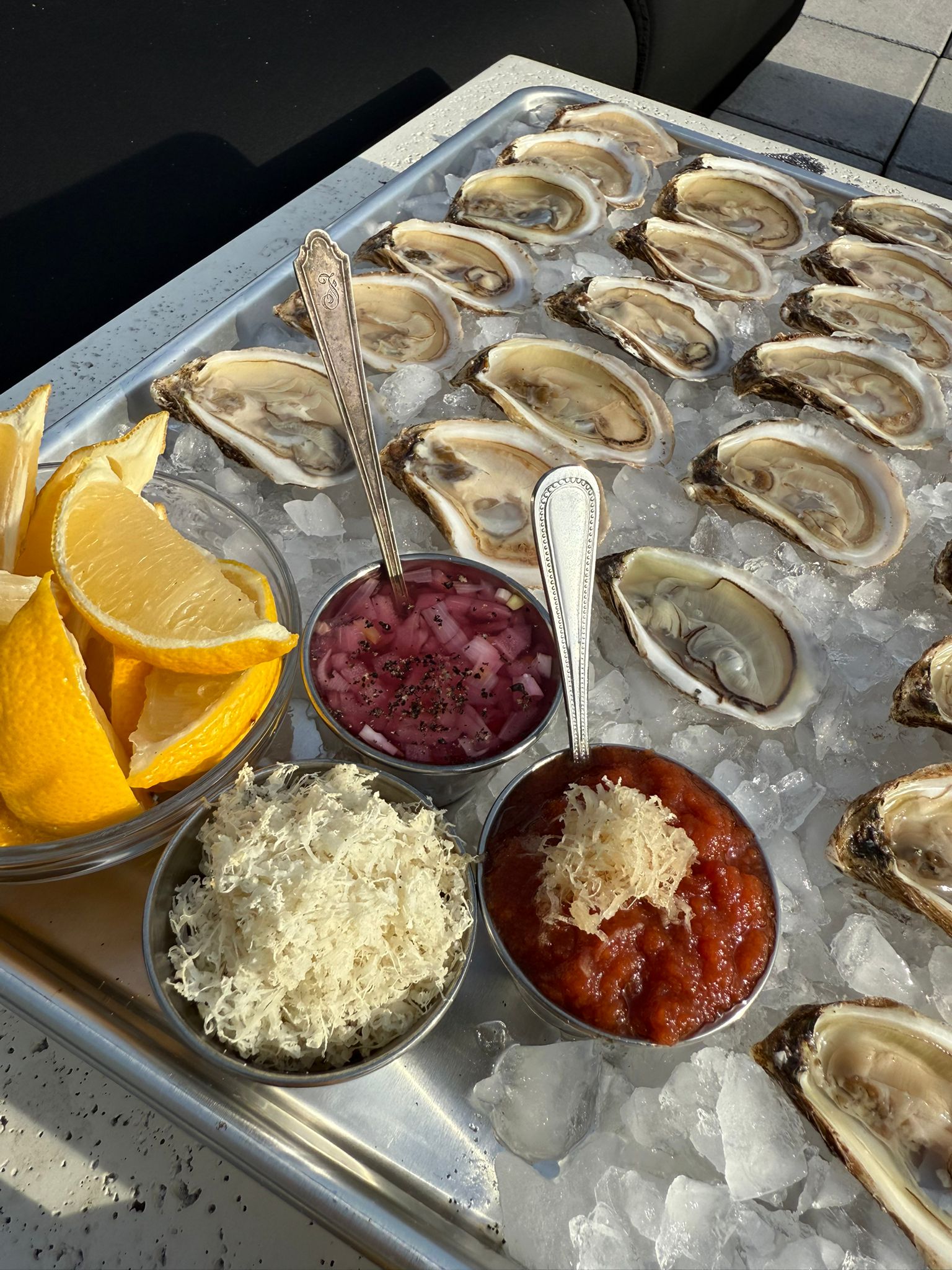 Fresh oysters on ice with condiments